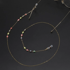 Golden chain eyewear strap featuring colorful evil eye beads and silicone loops
