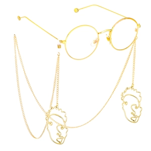Chaîne de lunettes dorée avec pendentifs visage abstrait sur monture ronde élégante