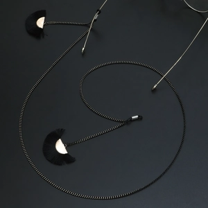 Minimalist black eyewear chain with golden fan fringe tassels for stylish sunglasses