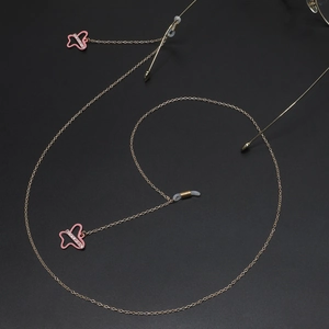 Golden eyewear chain with pink rhinestone butterfly pendants and non-slip rubber loops