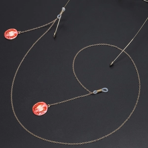 Golden metal glasses chain featuring creative tomato slice charms and silicone grips