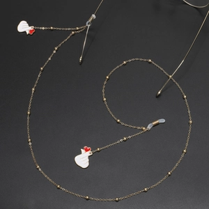 Golden beaded glasses chain featuring white enamel heart hand pendants on black background