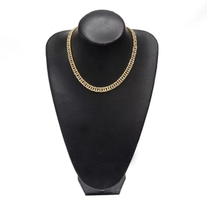 Classic gold Cuban link chain necklace displayed on a black neck mannequin stand