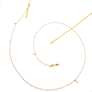 Rose gold glasses chain with white pearls and silicone loops on a clean white background