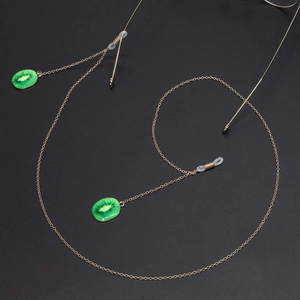 Chaîne à lunettes dorée avec pendentifs kiwi vert et boucles en silicone blanc