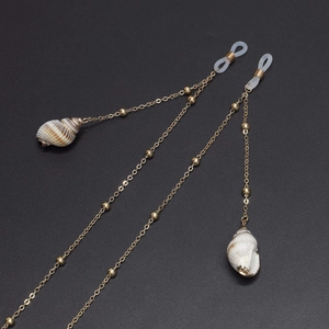 Golden eyewear chain with natural seashell pendants and metallic beads at 45-degree angle