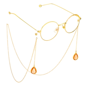 Golden round glasses with anti-slip metal chains and amber teardrop pendants on white background