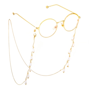 Minimalist gold round glasses with elegant pearl chain accessory in a floating view