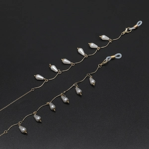Elegant gold glasses chain with white teardrop pearls and lobster clasps on black background