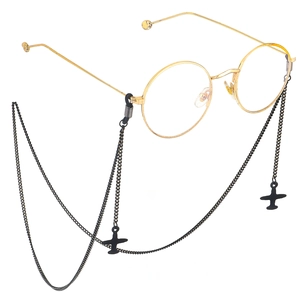 Black eyeglass chain with airplane pendants on gold round frame glasses 45-degree view