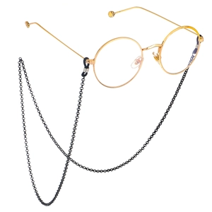 Detail of black non-slip glasses chain with rubber loops on gold round frames