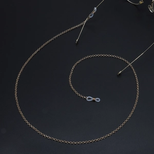 Chic gold circle chain sunglasses strap with silicone loops on a black background