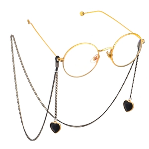 Golden round frame glasses with a black heart pendant decorative neck chain