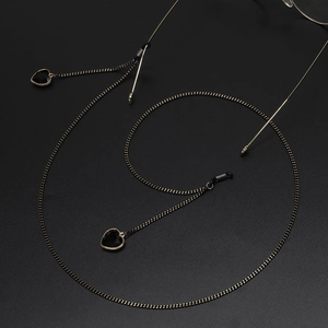 Golden eyeglass chain with black crystal heart pendants and silicone rubber loop connectors