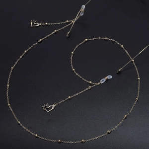 Catenella per occhiali dorata con ciondolo a cuore e corona con cristalli neri