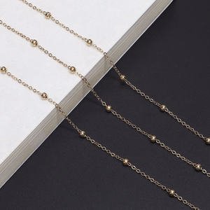 Minimalist gold metal eyeglass chain featuring polished beads on a thin cable link