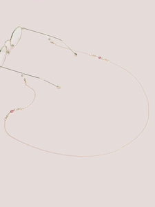 Detail of rose gold glasses chain with pink and green beads and silicone loops