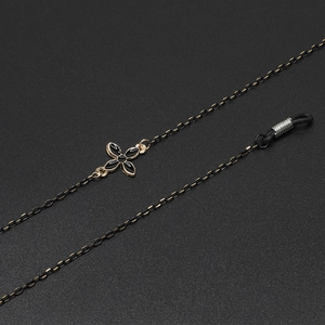 Chic black and gold eyewear chain featuring clover flower charms and adjustable loops