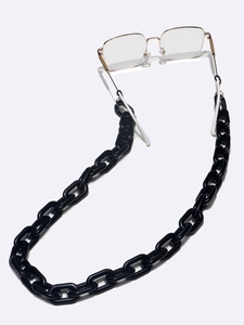 Detail of chunky black acrylic eyeglass chain with white adjustable rubber loops