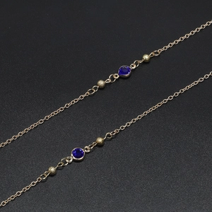 Detail of 70cm gold glasses chain with dark blue glass beads and frosted gold beads