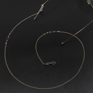 Detail of 70cm gold metal eyeglass chain with blue beads and anti-slip rubber loops
