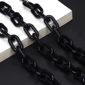 Glossy black acrylic eyewear chain featuring oversized oval links on a minimalist background