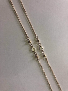 Detail of rose gold glasses chain with frosted metal beads and faceted crystals