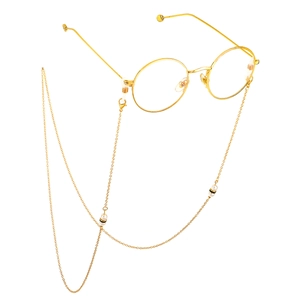 Golden metal round glasses with an elegant long pearl and rhinestone chain strap