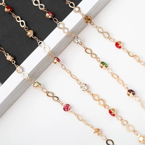 Luxurious gold eyeglasses chain with colorful rhinestones and infinity charm design