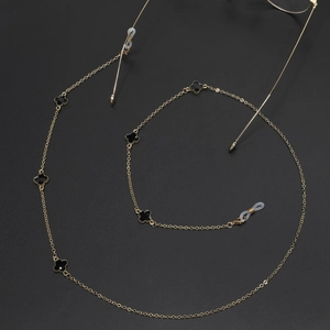 Golden metal glasses chain featuring five black clover charms and clear silicone loops