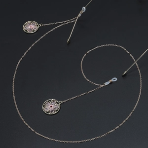 Golden anti-slip eyewear chain featuring floral wire pendants on a sleek black background