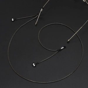 Fashionable black eyewear chain featuring round metal links and cute soot sprite pendants