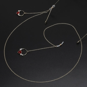 Golden eyeglass chain featuring red heart crystals and elegant white pearls for women