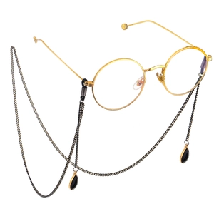 Fashionable gold round frame glasses with minimalist black chain and water drop pendants