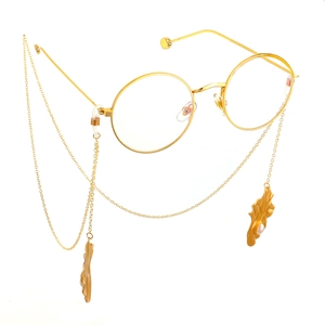 Golden round frame glasses with elegant pearl pendant chain and metallic leaf accents