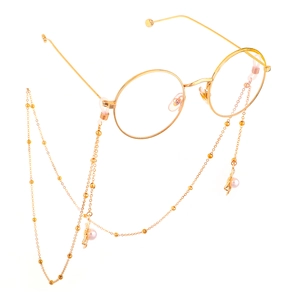 Golden round glasses with anti-slip chain featuring pearl pendants and metal leaves