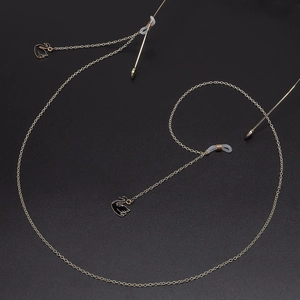 Elegant gold metal glasses chain featuring black swan pendants and non-slip silicone loops