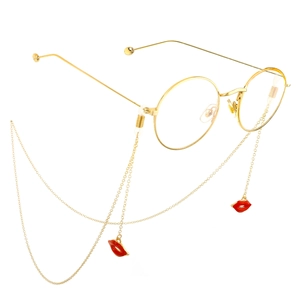 Gold round metal glasses with elegant red lip pendant chain on white background