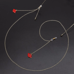 Golden metal eyewear chain featuring red lip enamel charms and anti-slip silicone loops