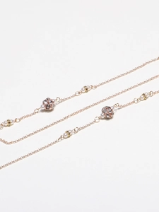 Detail of gold lantern chain with white pearls and sparkling rhinestone spheres