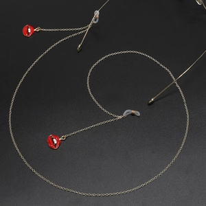 Golden metal eyewear chain with stylish red lip charms and non-slip silicone loops