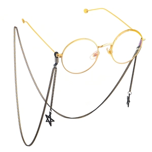 Gold round frame glasses with black metal chain and hollow star pendants on white background