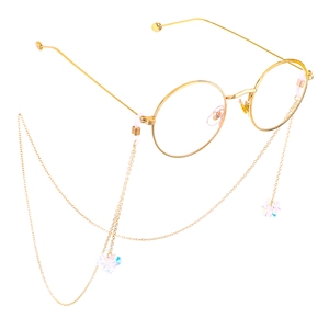 Elegant gold metal glasses chain with sparkling crystal charms on a white background