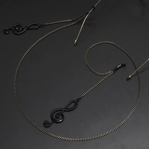 Fashionable eyewear chain with gold-black link links and treble clef music note pendants