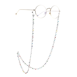 Handmade colorful beaded eyewear chain with gold vintage round glasses on white background