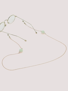 Detail of rose gold glasses chain with mint green textured beads on eyeglass temples