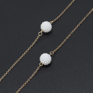 Golden eyeglass chain featuring delicate metal links and white pearl bead sphere charms