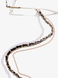 Detail of multi-layer eyewear chain with pearls, gold metal, and black leather strap