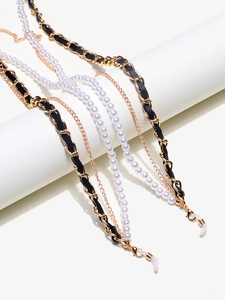 Detail of multi-layer eyeglass chains with gold metal fringe, pearls and leather weaving