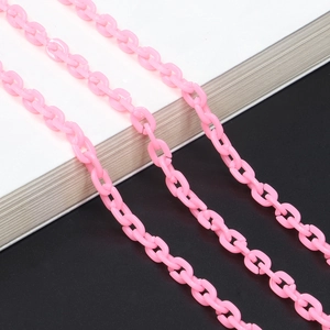 Pink acrylic resin chain for glasses and bags with smooth oval links on a modern display